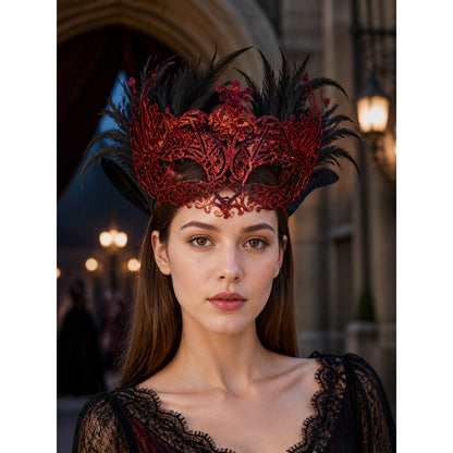 Red glitter filigree mask with black feathers worn by a woman in a black lace dress
