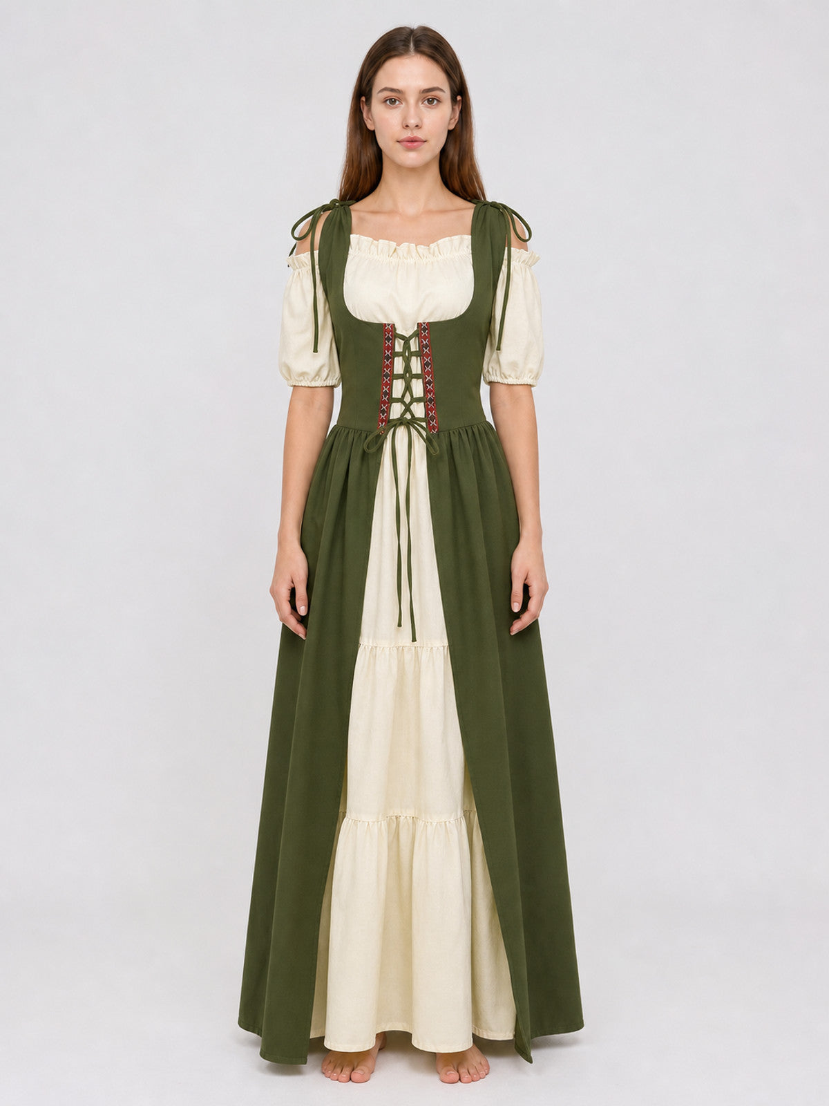 Full-body model wearing a green and cream dress with a laced bodice, puff sleeves, shoulder ties, and a layered skirt
