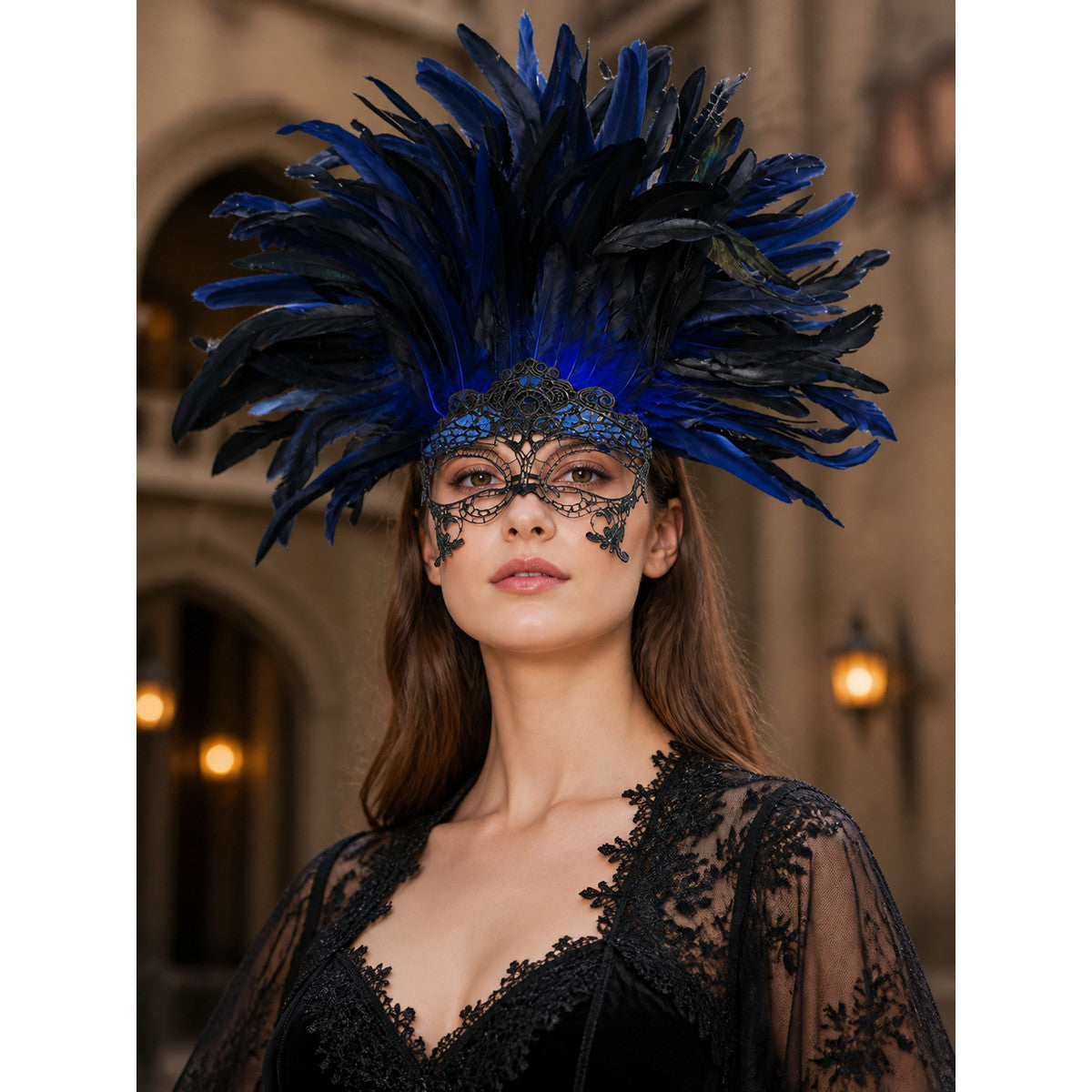Feathered masquerade headpiece in blue and black with a filigree eye mask, shown close-up on a model in a black lace outfit