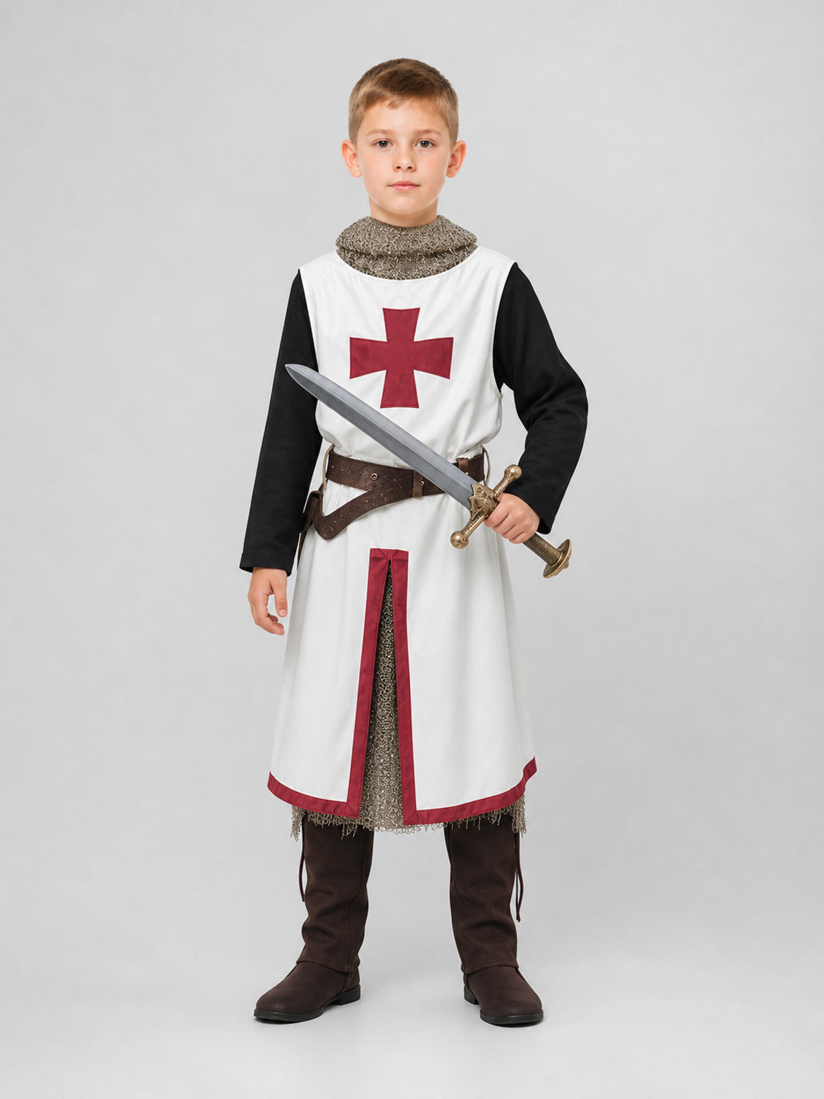 White tunic with red cross, black sleeves, chainmail-look collar, brown belt, dark trousers, boots and sword shown full-body on a child model