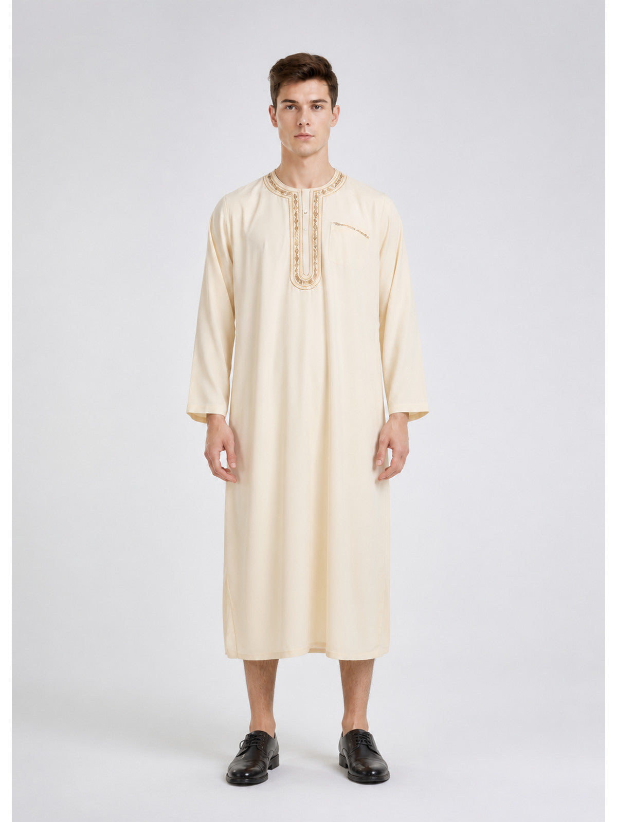 Cream long tunic robe in smooth fabric with embroidered round neckline and chest pocket, shown full-body on a model wearing black shoes