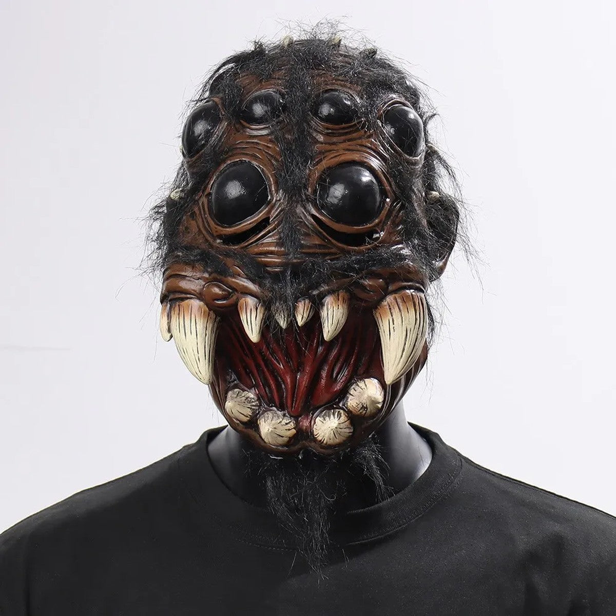 Spider half face latex mask on a mannequin, front view showing bulging black eyes, curved fangs and black fur