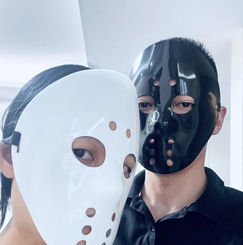White and black full-face hockey masks worn by two adults