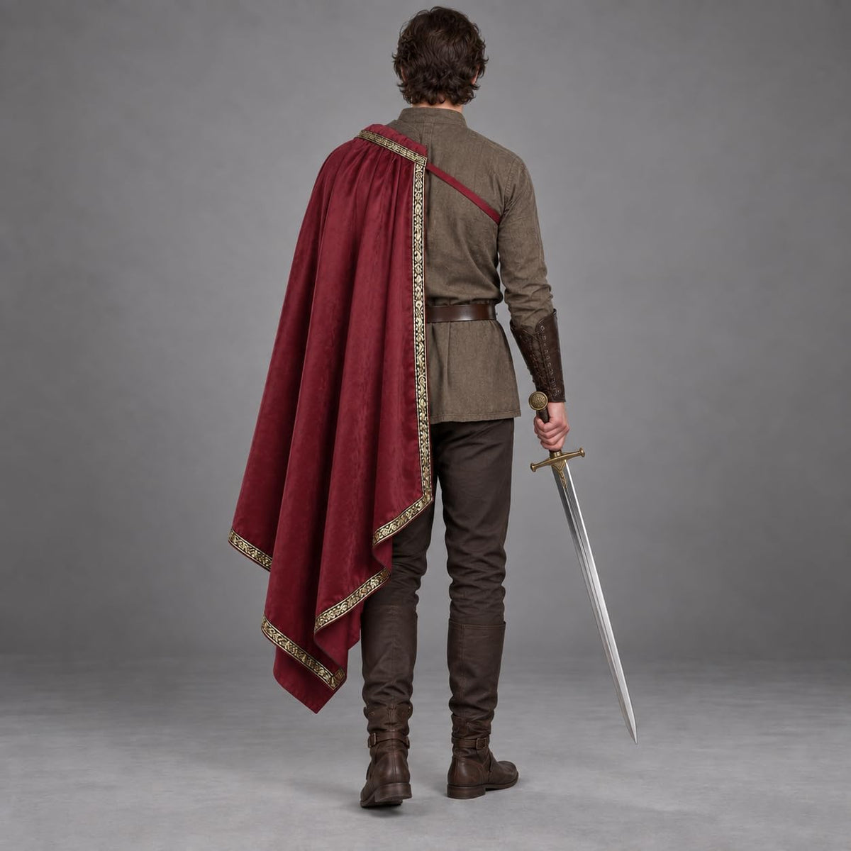 Back view of the burgundy half-shoulder cape showing its full length and gold-tone trimmed edge
