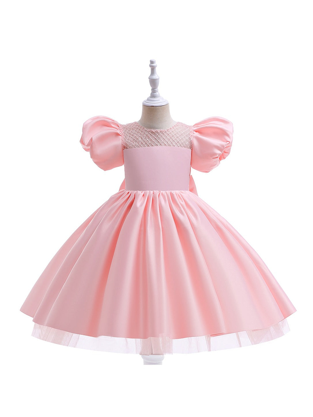 Pink girls' princess dress on a mannequin showing the diamond-grid mesh yoke, puff sleeves and tulle under the hem