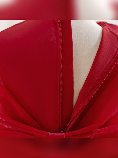 Close-up of the back zipper and bow on the girls' red princess dress