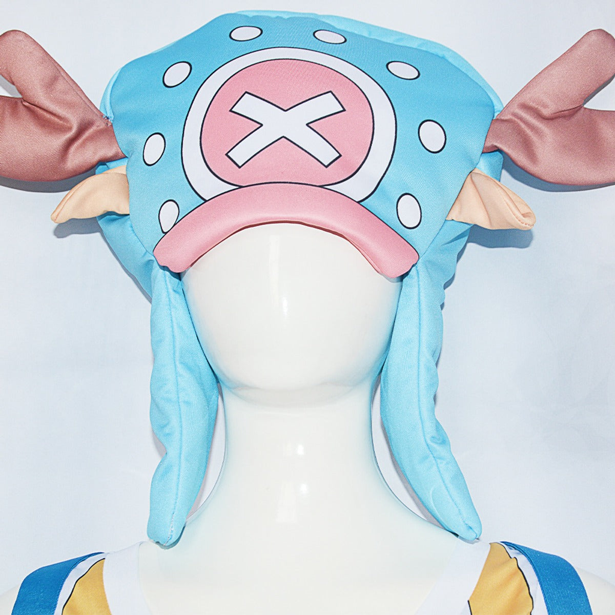 Close-up of the blue Chopper cosplay hat with brown antlers, pink cross emblem and ear flaps