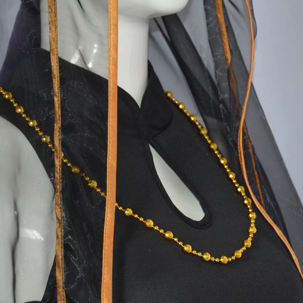 Close-up of the stand collar keyhole neckline, gold bead necklace and gold-edged sheer veil