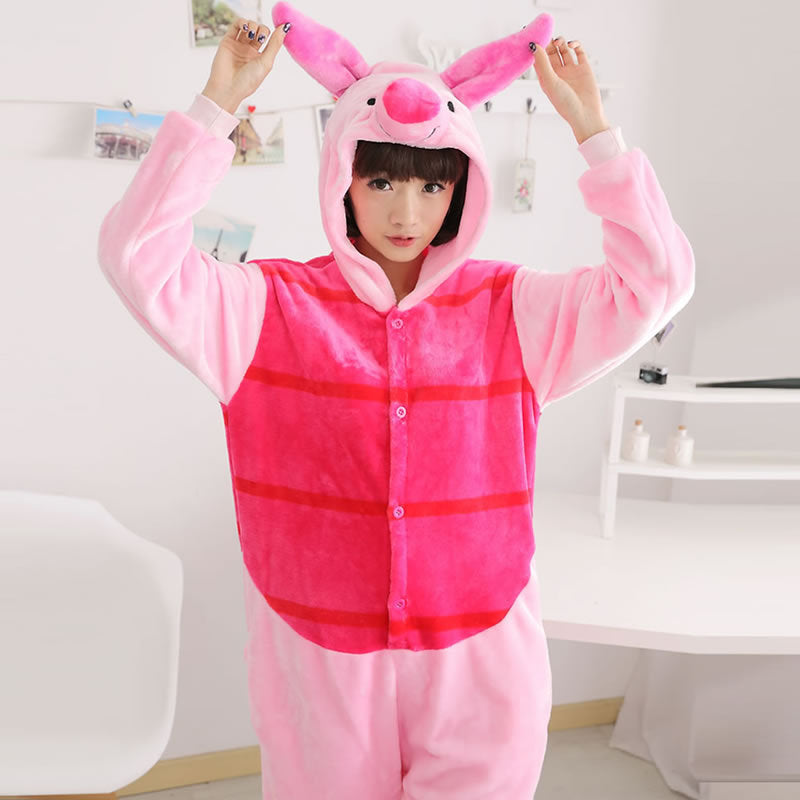 Adult wearing the pink pig onesie pajamas with the hood up, front view