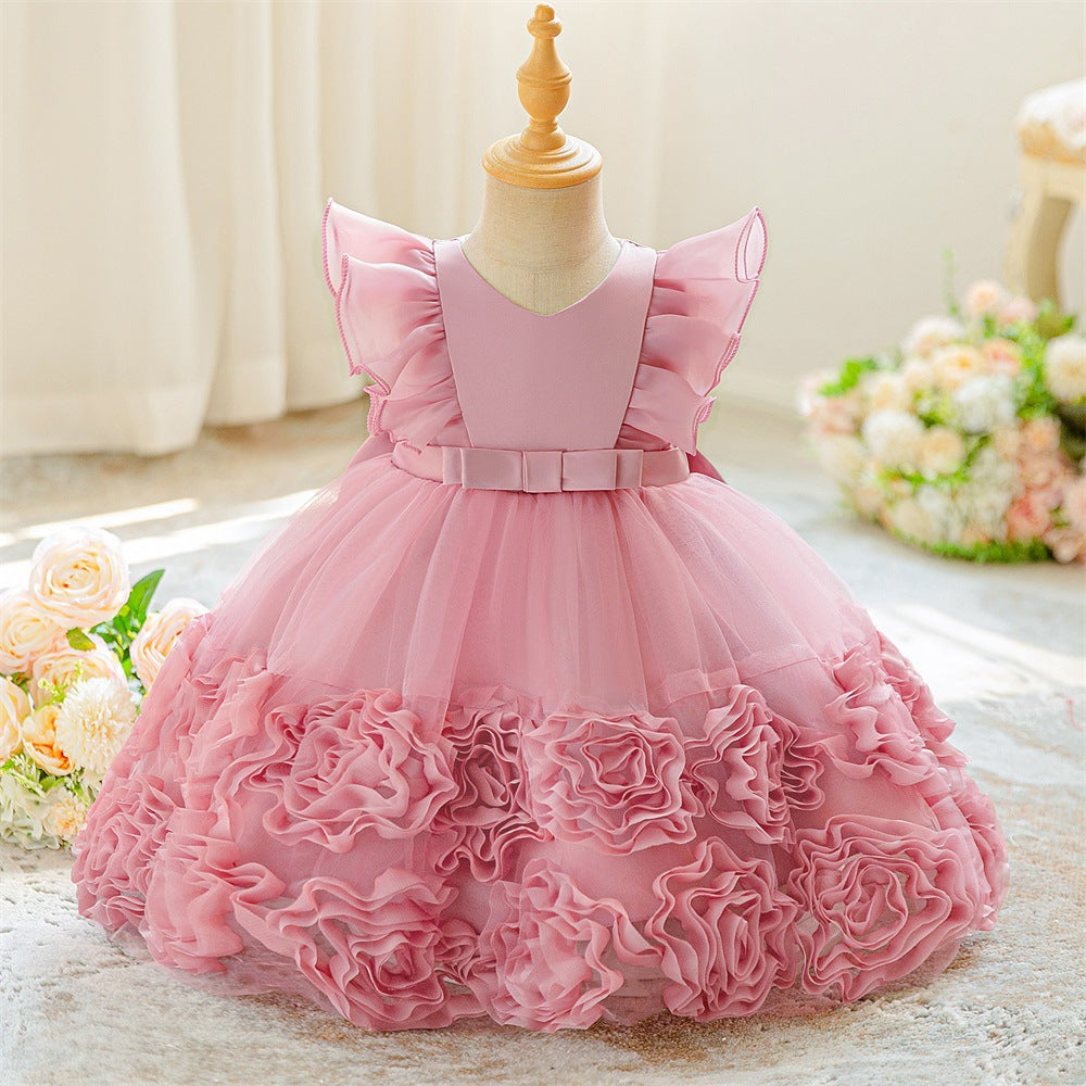 Real product photo of the dusty pink tulle princess dress on a child mannequin, front view with rose ruffle hem