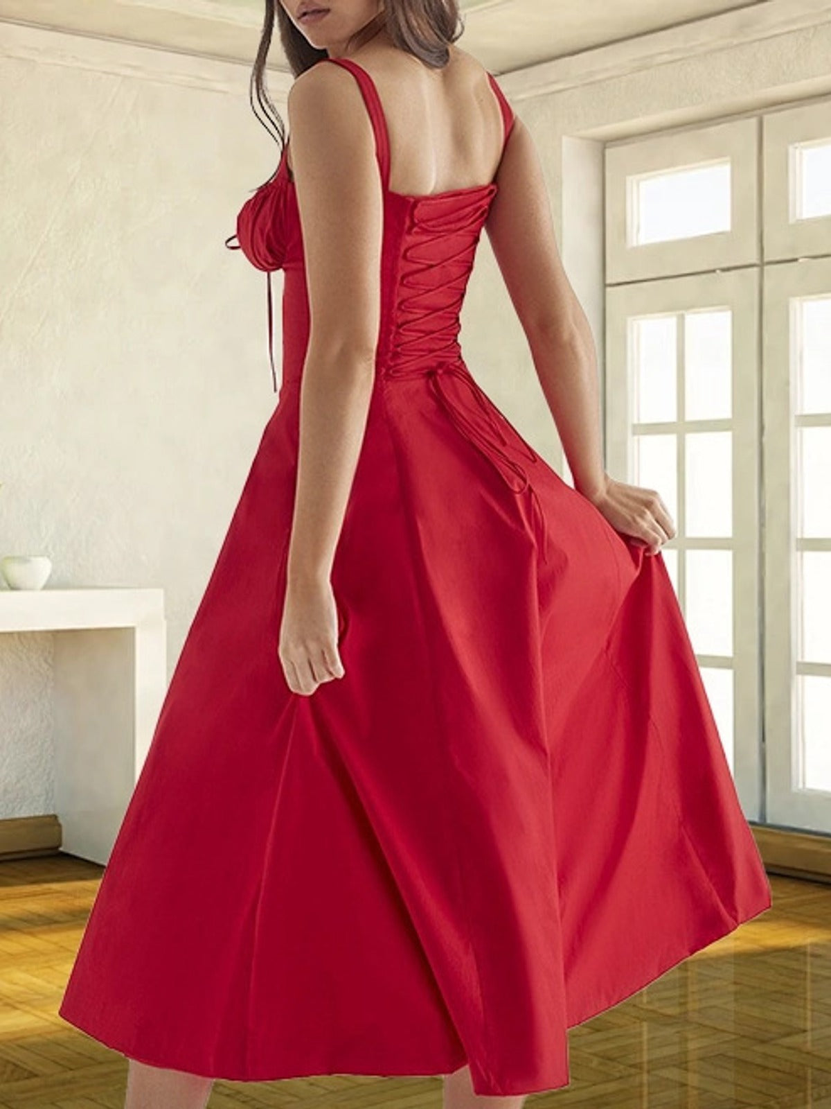 Back view of the red corset midi dress showing the lace-up back, thin straps and full A-line skirt
