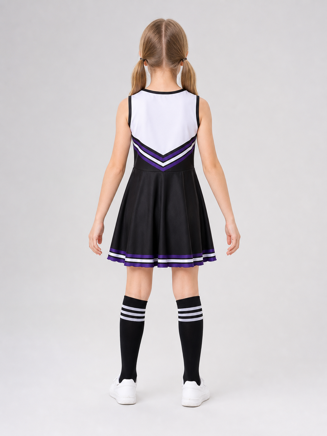 Cheerleading costume with pom-poms, dress, and leg warmers