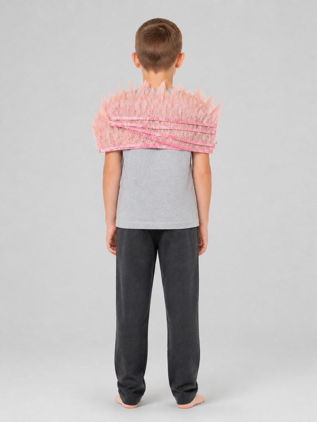 Pink feather headpiece with layered bands, shown from the back on a full-body child model
