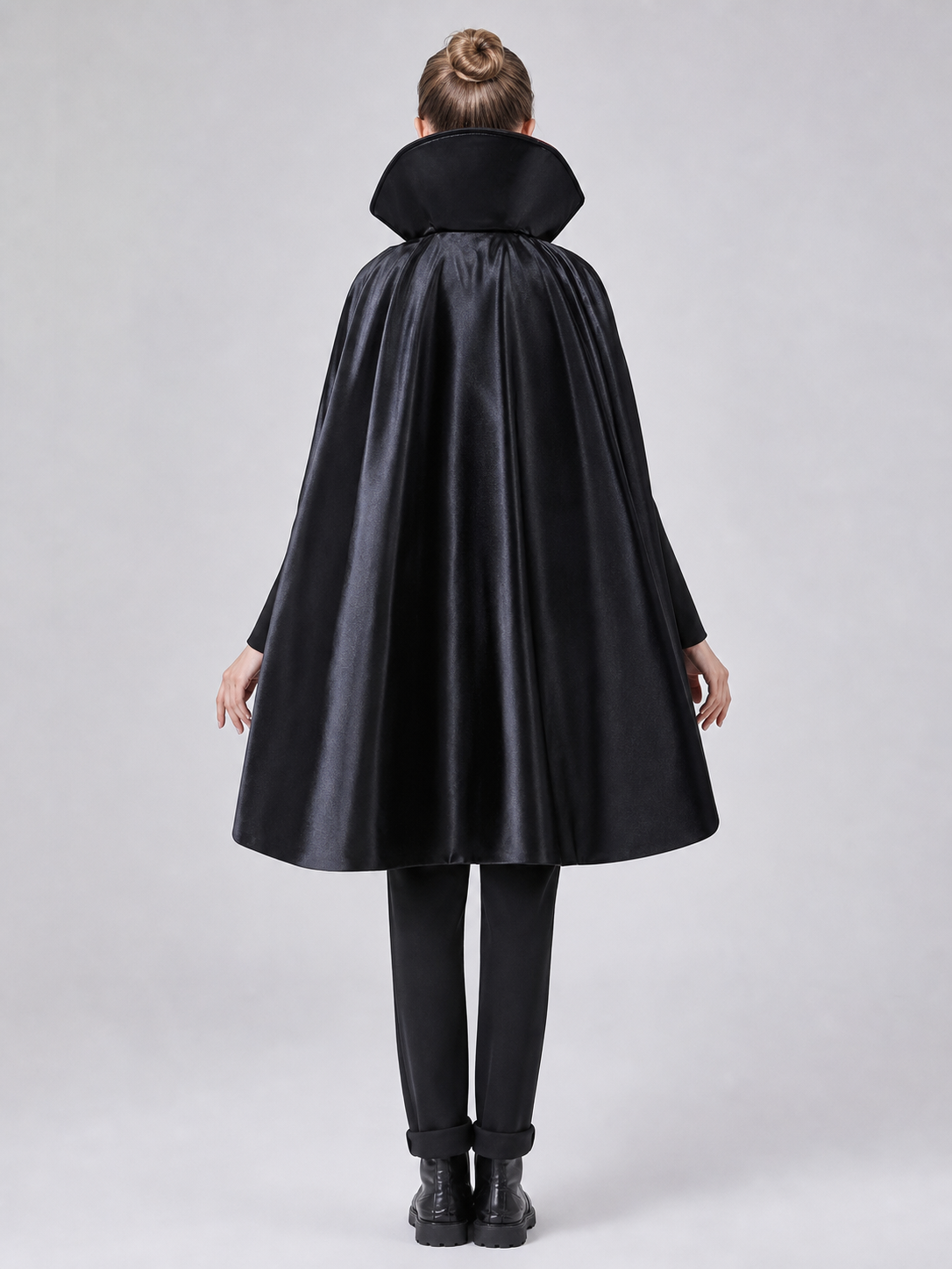 The long black cape is designed to create a vampire look for cosplay, Halloween, and stage performances. The cape is black and features a loose silhouette with long, draping panels and an opening lower edge. The upper section has a hooded o