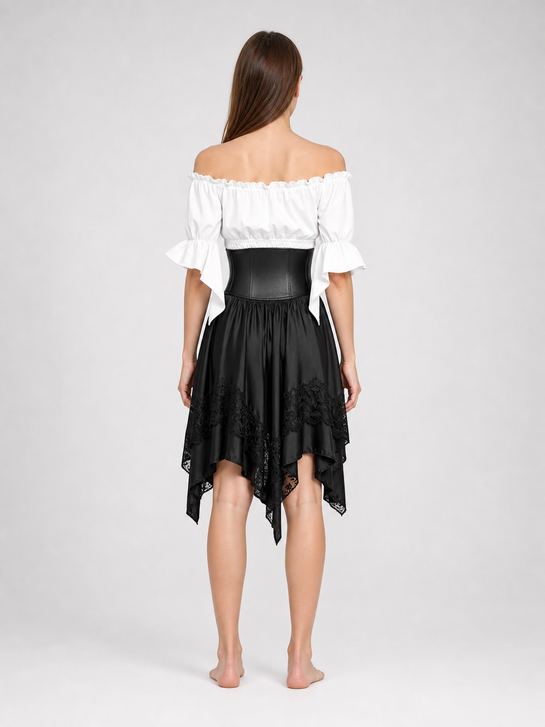 The set is designed in a theatrical pirate style and consists of a white cropped off-the-shoulder top with voluminous puff sleeves, a black corset with front lacing and metal eyelets, and a black asymmetrical skirt with elongated pointed pa