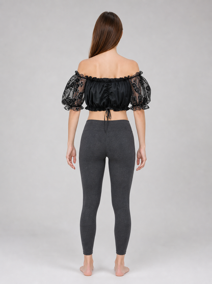 The blouse is black: the main body is made of opaque, smooth fabric