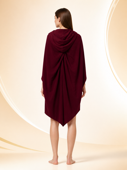 Back view of a burgundy hooded cloak on a woman, showing the draped hood and long pointed back hem