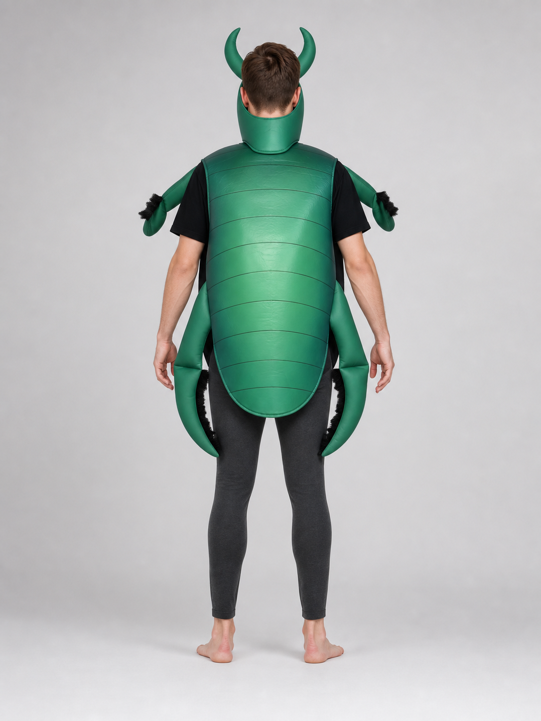 The beetle costume features a full-body insect silhouette with a large segmented green panel on the abdomen. The look is completed by a curved headpiece resembling horns, along with green side and hand elements that imitate insect limbs. Th