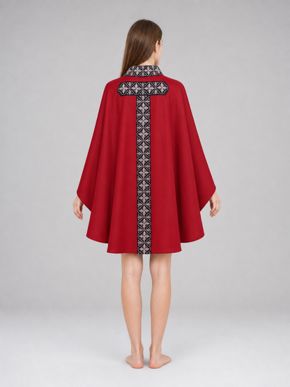 The cape is red with black decorative elements. It has a loose cloak-style silhouette, wide sleeves, and a collar with black patterned detailing. The front features a vertical decorative stripe down the center and a horizontal stripe across