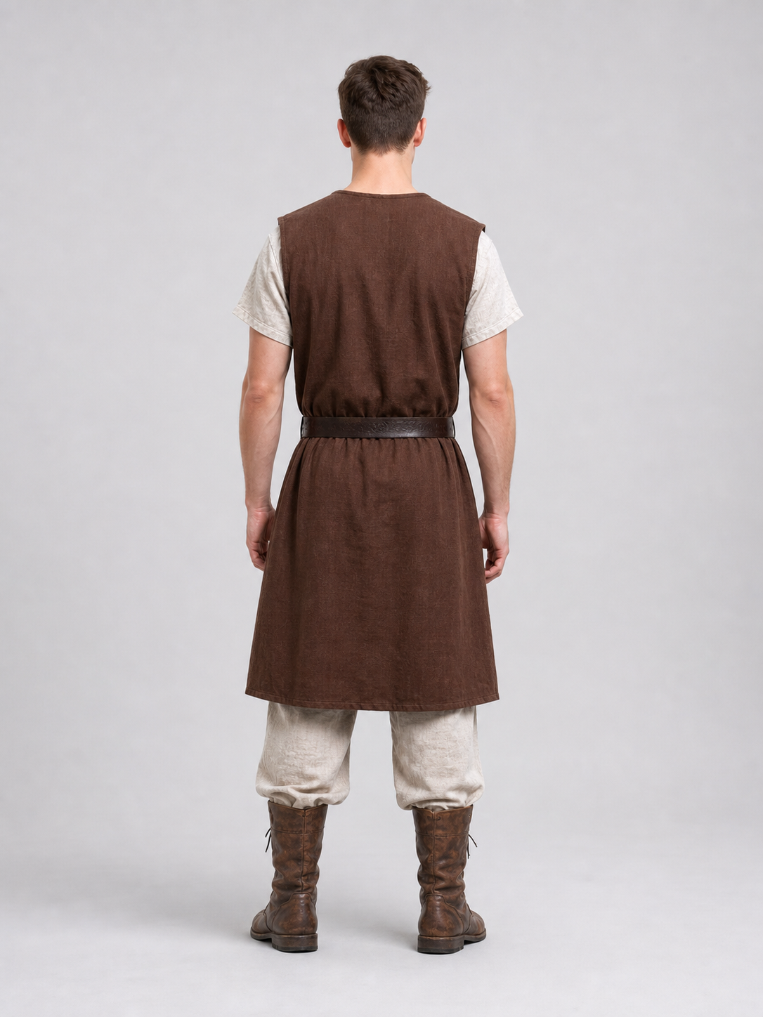 Close-up of a brown sleeveless tunic showing the round neckline, fur shoulder trim, cross-body strap and waist belt