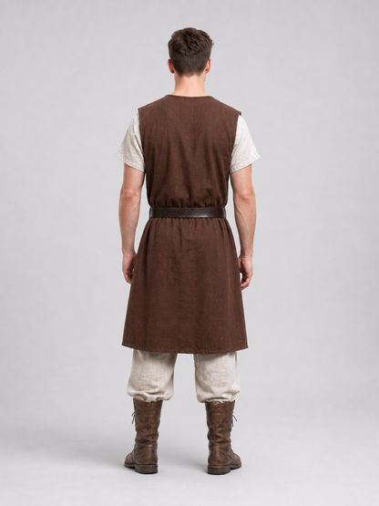 Close-up of a brown sleeveless tunic showing the round neckline, fur shoulder trim, cross-body strap and waist belt