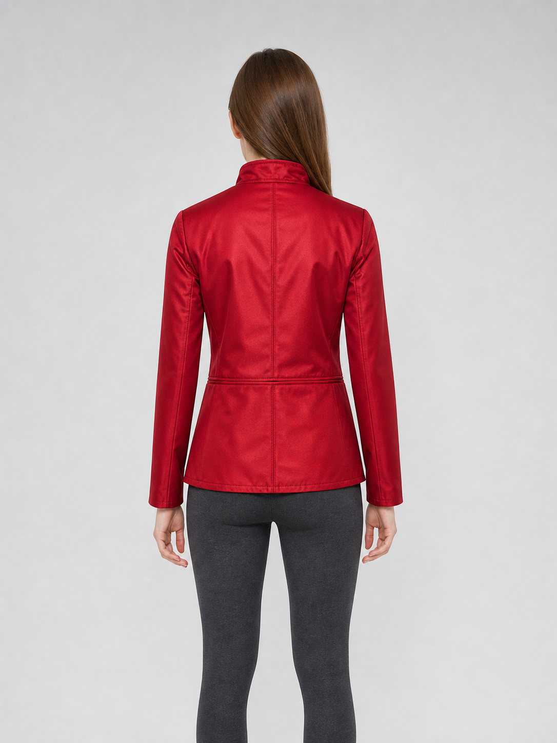 The jacket is presented in a vintage red color and designed in a military style with elements of Gothic aesthetics. The model features a distinctive front construction with a diagonal wrap, giving the garment a bold character. A double row 
