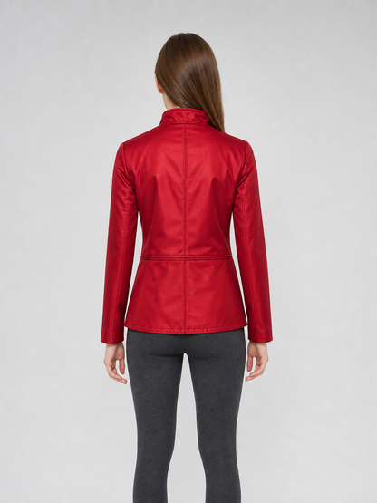 The jacket is presented in a vintage red color and designed in a military style with elements of Gothic aesthetics. The model features a distinctive front construction with a diagonal wrap, giving the garment a bold character. A double row 