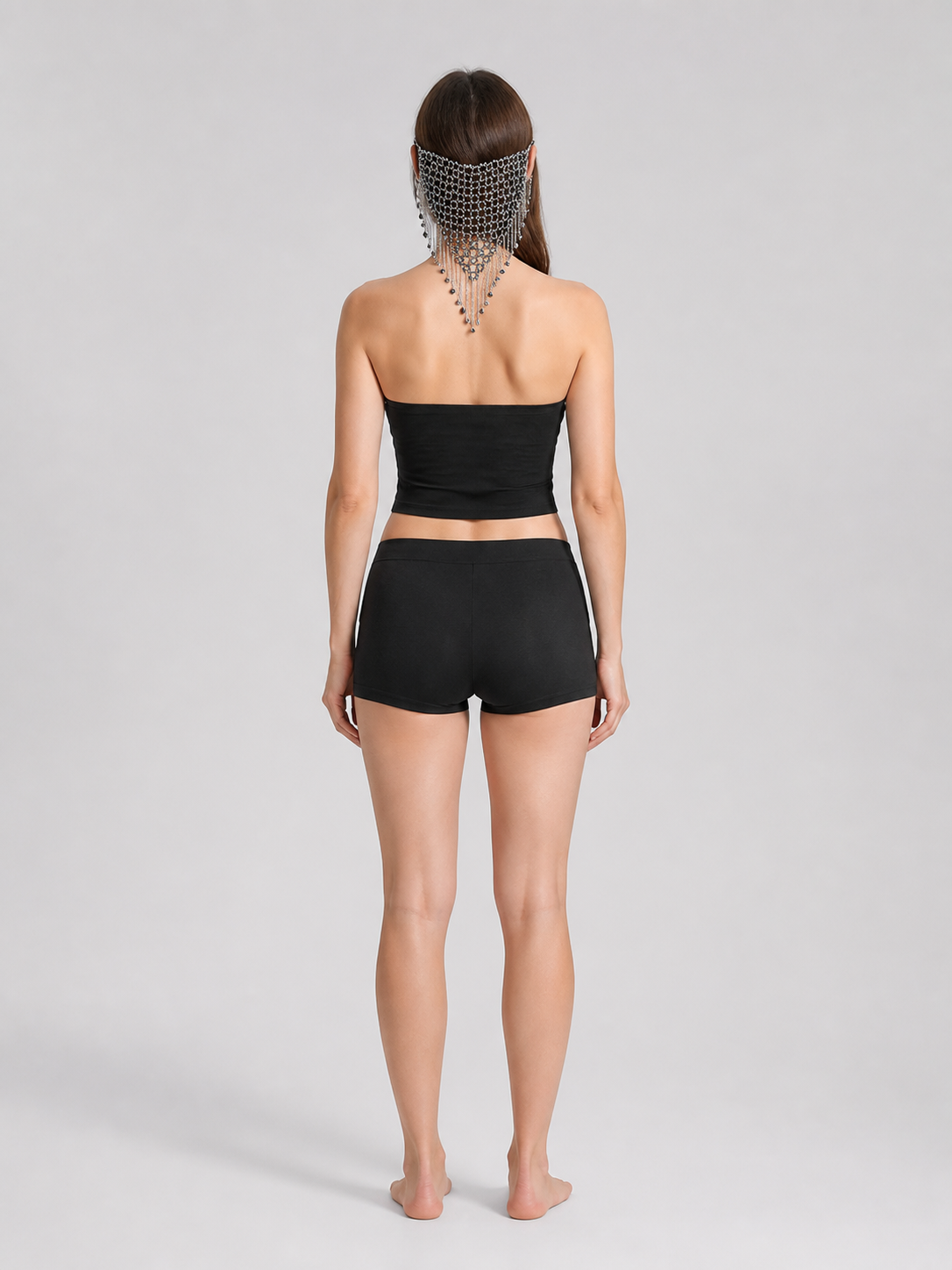 Back view of a model wearing the black and silver chain mask, showing the mesh across the head and chains hanging down the neck