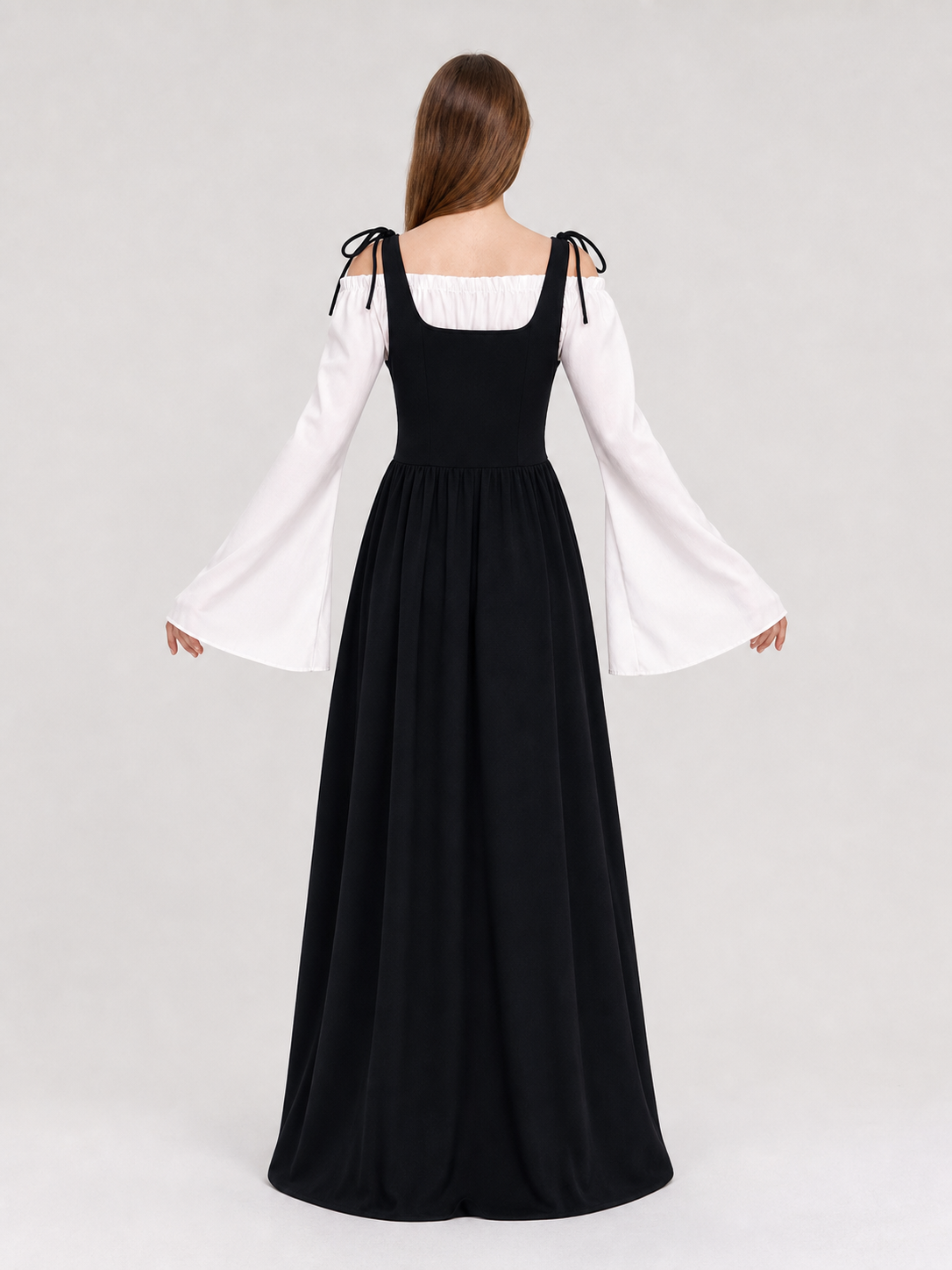 The dress is designed in a vintage medieval style and features characteristic elements of Renaissance-era clothing. The main part of the design is black, while the white details create a striking contrast. The fitted black bodice features a