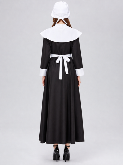 The uniform costume is designed in a black-and-white color scheme and combines elements of a classic maid outfit with a stage costume format. The model creates a complete look with a black top and skirt, long sleeves, white cuffs, a wide wh