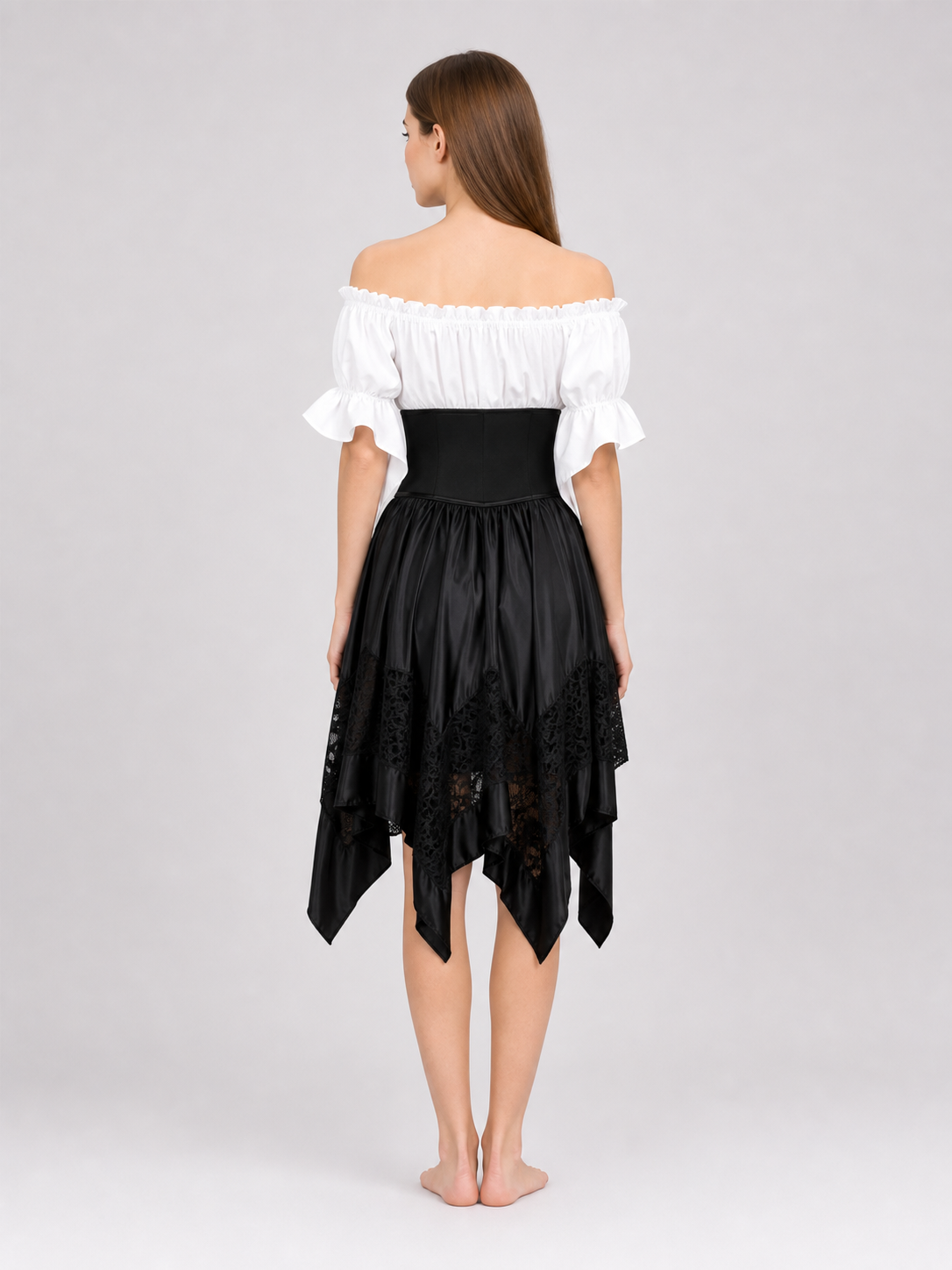 The set is designed in a theatrical pirate style and consists of a white cropped off-the-shoulder top with voluminous puff sleeves, a black corset with front lacing and metal eyelets, and a black asymmetrical skirt with elongated pointed pa