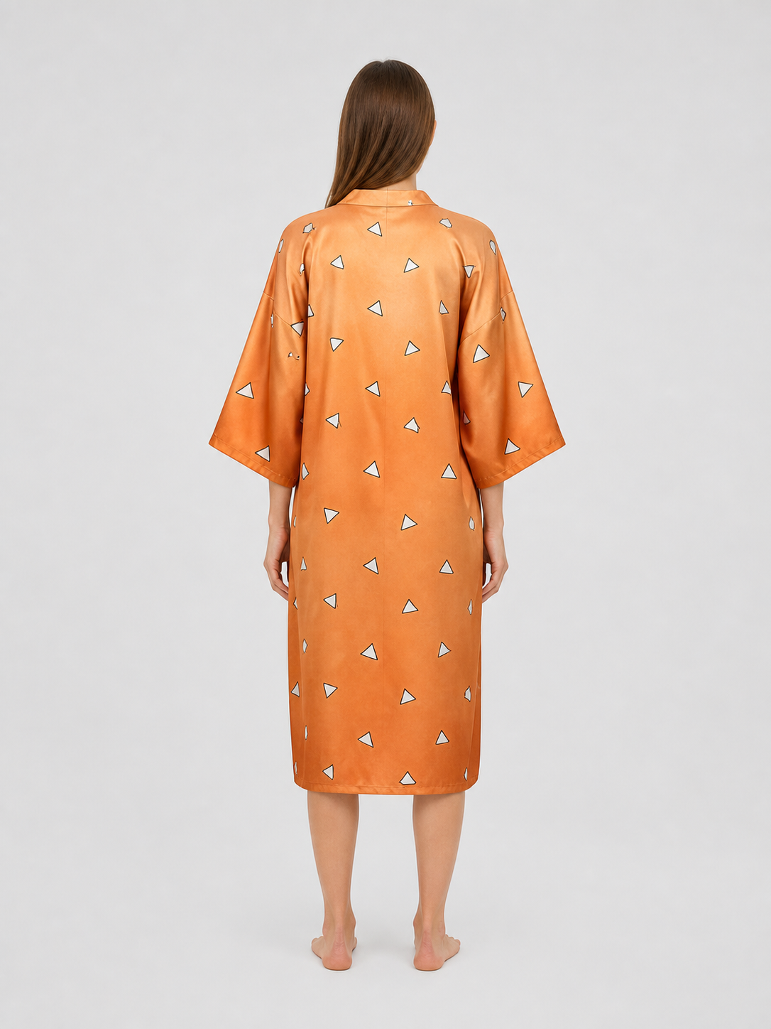 Back view of an orange satin-look robe with wide sleeves and scattered white triangle pattern