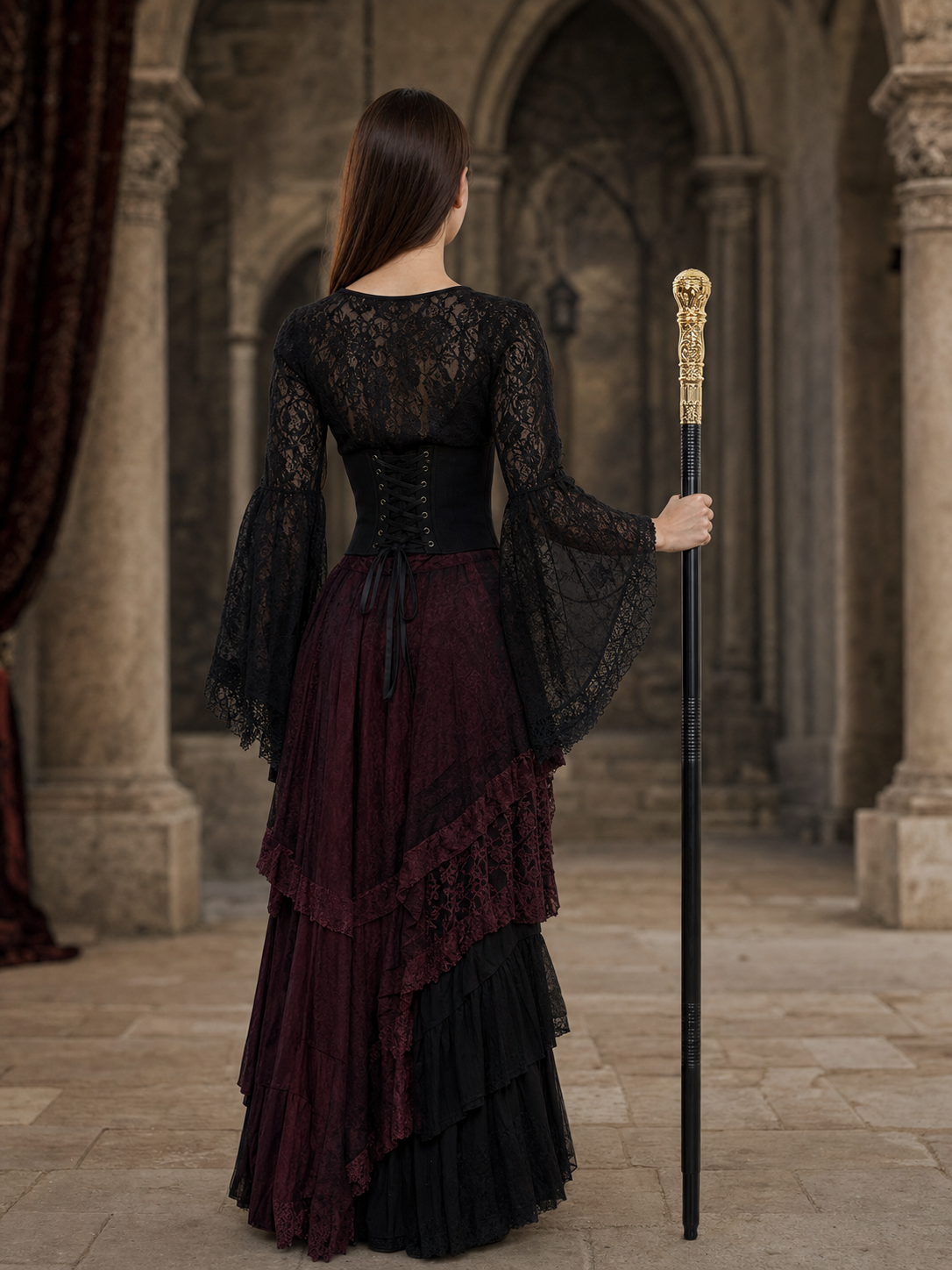 Black-shafted gold handled scepter held by a woman shown from behind in a layered black and burgundy gothic dress