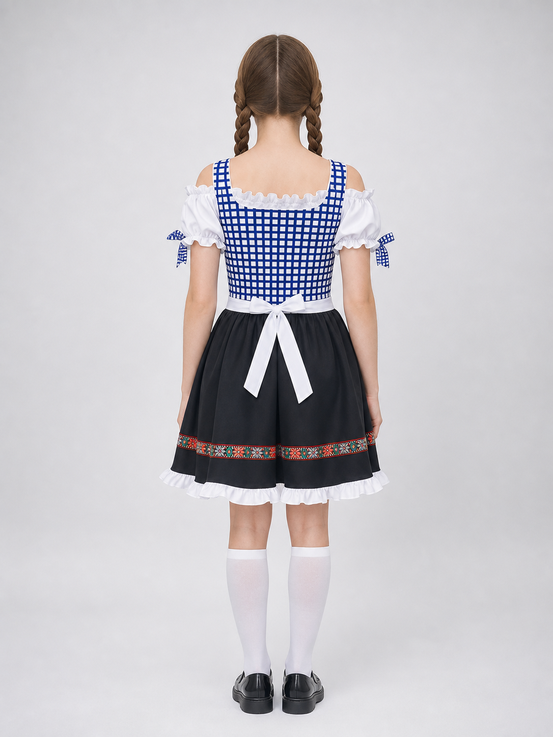 Historical national costume featuring a blue-and-white check pattern with a black lower panel. The design includes a white apron front and long blue lacing on the chest. Red-and-green ethnic patterns adorn the decorative shoulder bands, wai
