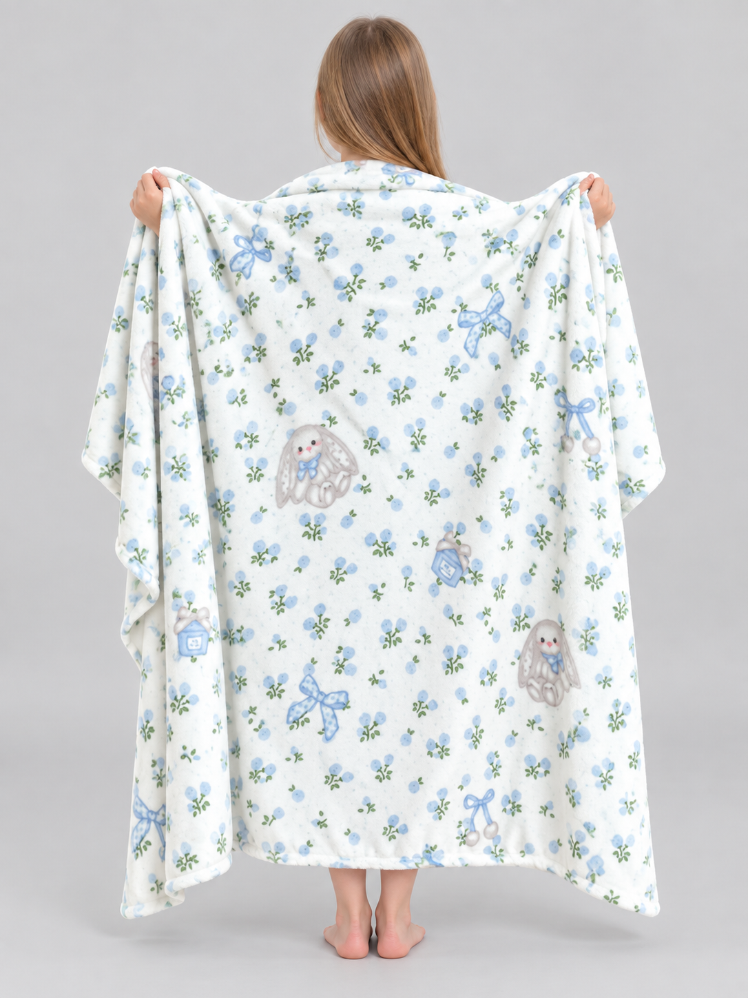 Reversible white blanket with a rabbit and bow pattern