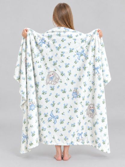 Reversible white blanket with a rabbit and bow pattern