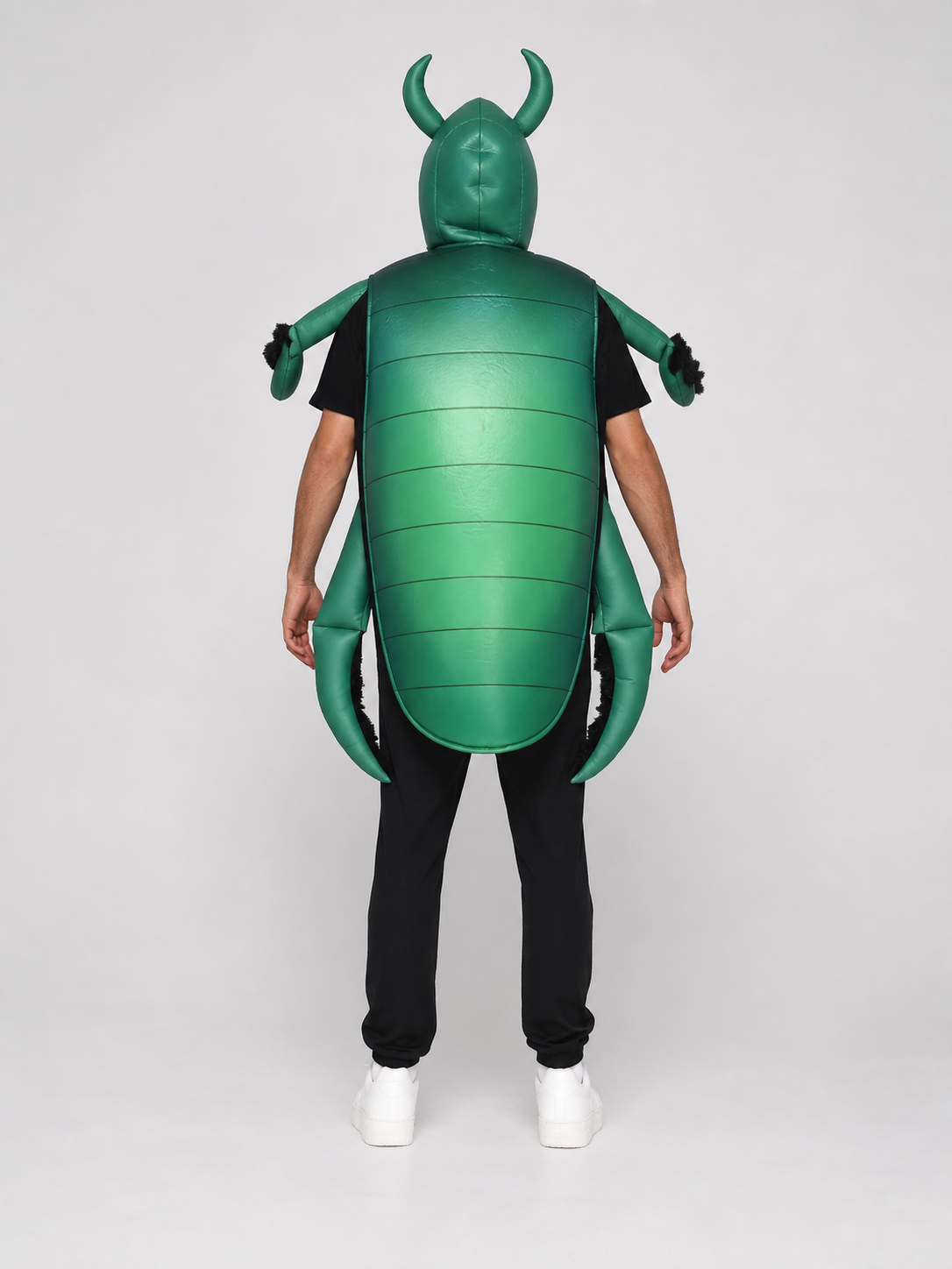 The beetle costume features a full-body insect silhouette with a large segmented green panel on the abdomen. The look is completed by a curved headpiece resembling horns, along with green side and hand elements that imitate insect limbs. Th