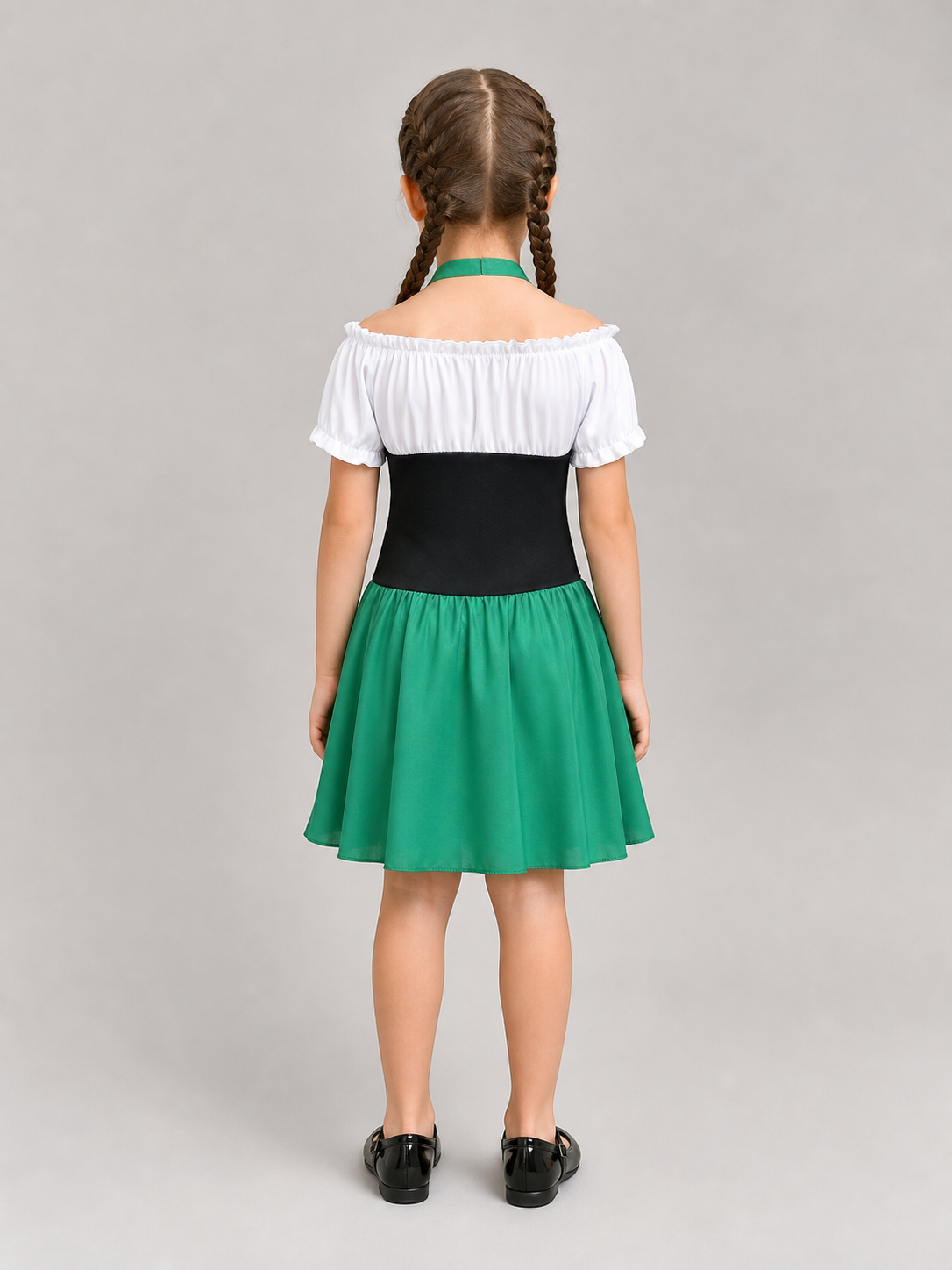 The dress is designed in a combination of white, green, and black. The silhouette emphasizes the waist and features a flared skirt. The design is finished with voluminous white short sleeves, a green tie collar, and green polka-dot trim. Th