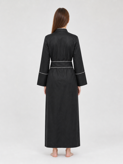 The model is designed in black and styled as a costume for cosplay, Halloween, and masquerades. It is a black cassock with a front featuring white buttons, a stand-up collar, and long sleeves. White crosses are placed on the garment: one is