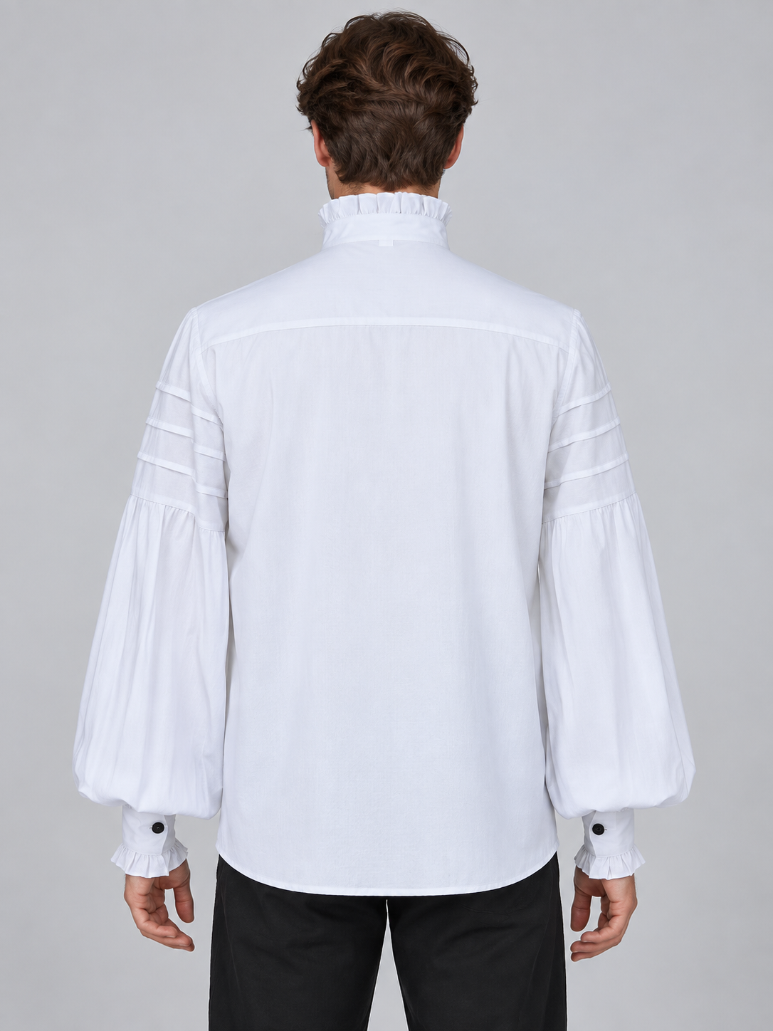 White shirt with a high collar, ruffles, and a brooch