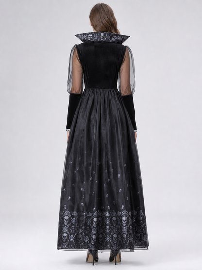 Black gothic-style dress with silver-white decorative skull motifs. The design features a long silhouette with sheer mesh sleeves and an accent neckline with a pointed shape. Silver decorative trim is placed across the chest, complementing 