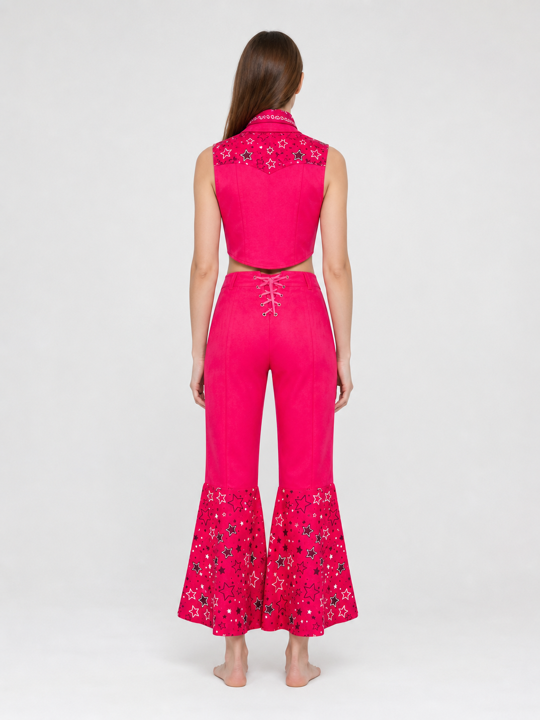 Barbie-style cosplay set consisting of two pieces: a cropped sleeveless top and flared-leg pants. The top resembles a vest with a front button closure, a decorative yoke, and a styled collar area. The pants have a high waist, front lacing, 