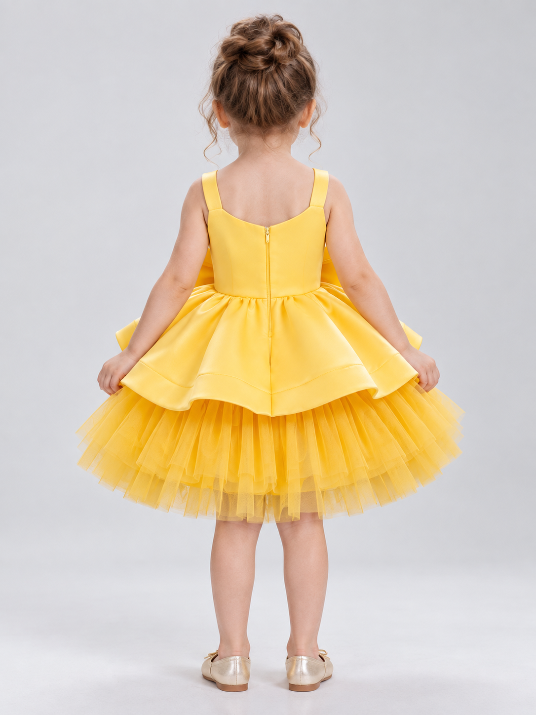 Yellow dress with a bow and a multi-layer tulle skirt