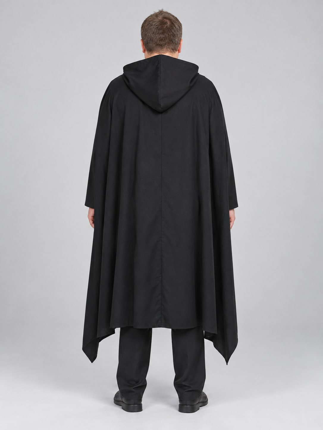 Black costume with white cross, hood, and belt