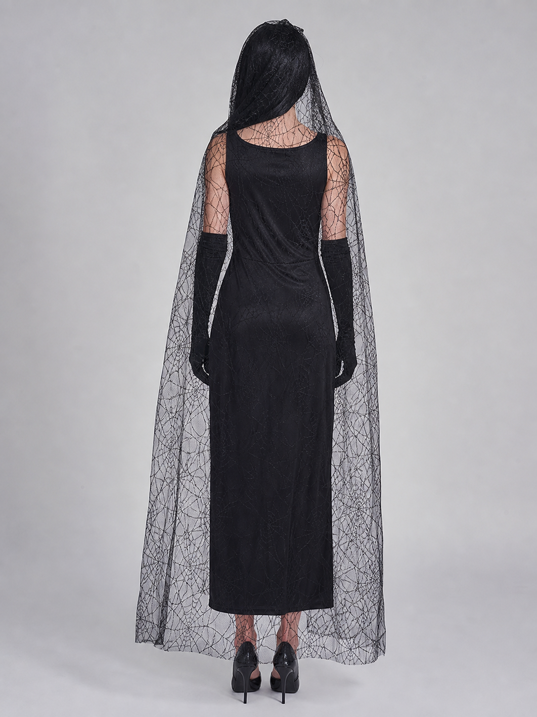 Gothic Halloween costume dress with accessories: a sleeveless black dress with a white rib and pelvic bone print, a sheer cape or veil with a spiderweb design, black gloves, and a necktie or bow detail. The look is done in black and white w