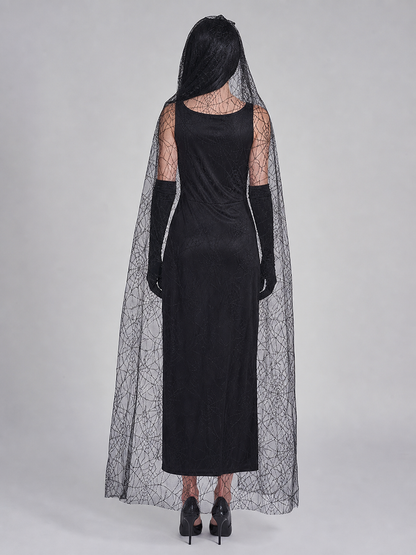 Gothic Halloween costume dress with accessories: a sleeveless black dress with a white rib and pelvic bone print, a sheer cape or veil with a spiderweb design, black gloves, and a necktie or bow detail. The look is done in black and white w
