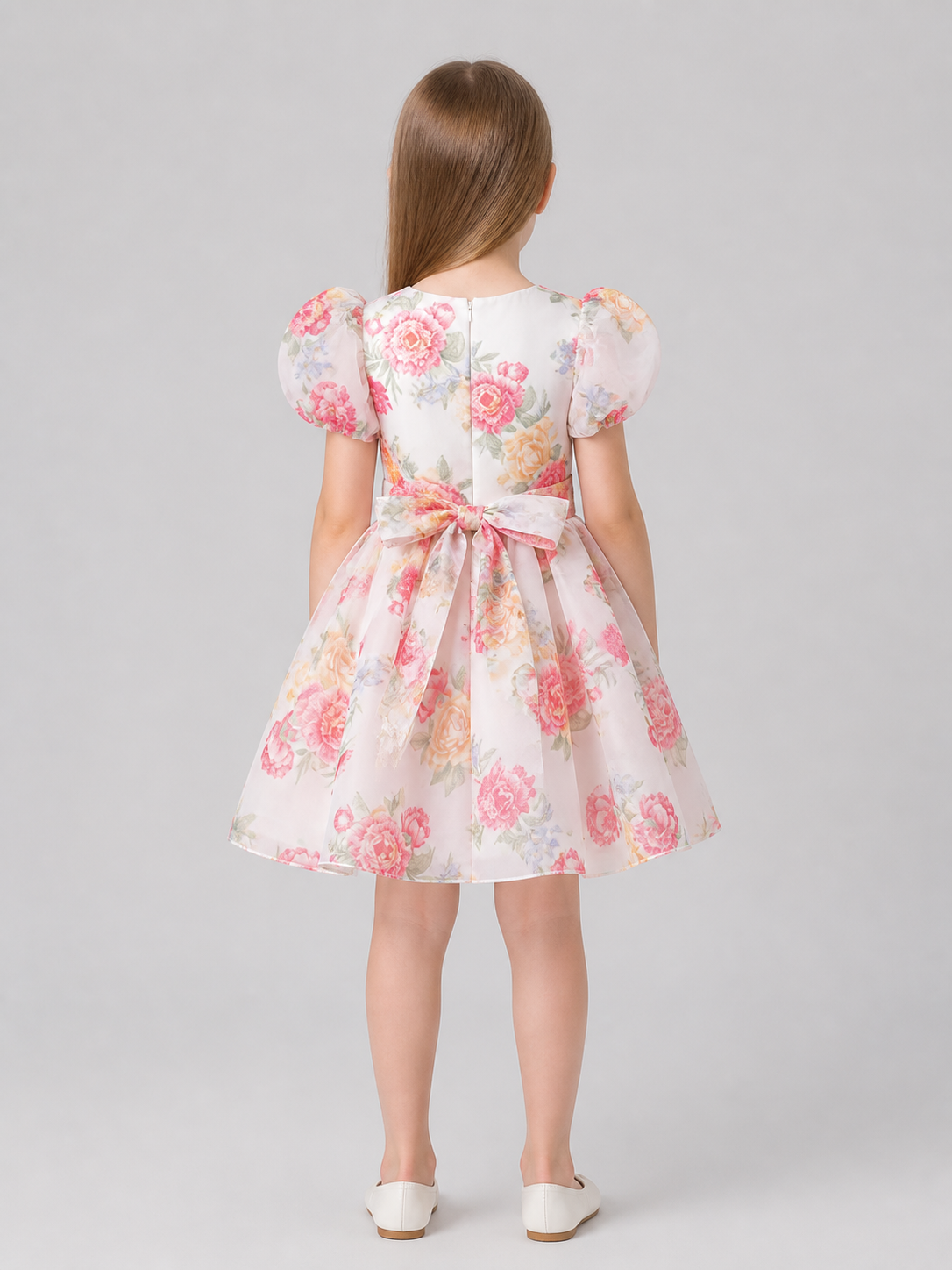 Children's dress with rose print, puff sleeves, and bow back view