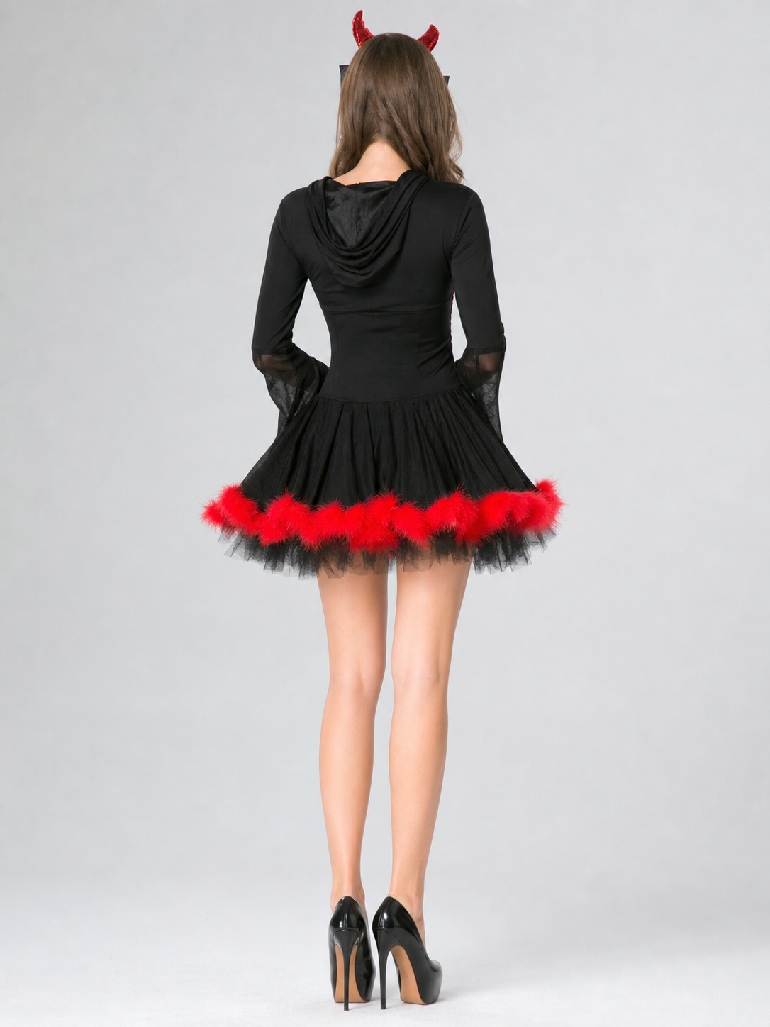 The magic of the look is revealed in the details of this costume: a black dress-style base is complemented by red accents and contrasting elements. The front features crisscross lacing and red trim that emphasizes the garment’s construction