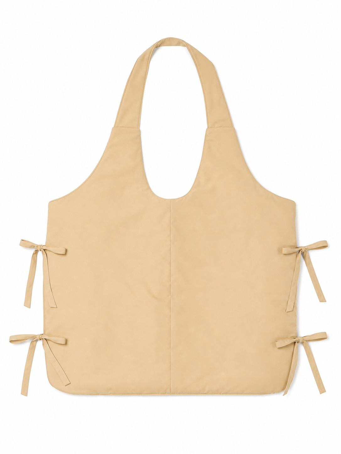 Wearable fake belly costume accessory with a large rounded shape. The model has a bib-style front panel, two shoulder straps, and side ties for fastening. The smooth solid-color surface comes in a light beige or beige shade, so the accessor