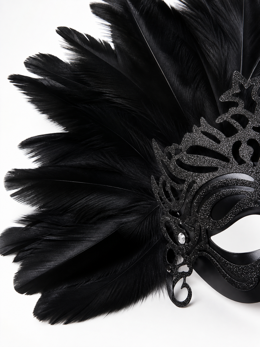 Carnival headpiece with black feathers and a mask